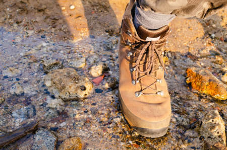 Hiker's leather boot while crossing a brookの写真素材