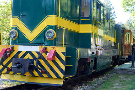 Green locomotive parked in a railway station - detail