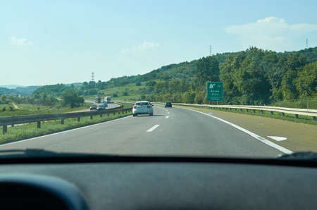 Traffic on a highway going through a picturesque landscapeの写真素材