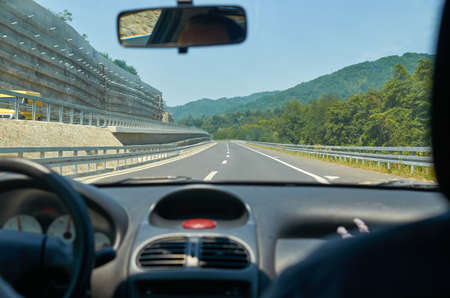 Motorway through a picturesque landscape seen from a car in motionの写真素材