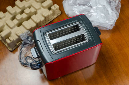 Brand new black-red toaster just unpacked - shot partly from above