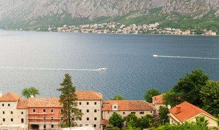 Impressive aerial view to the part of Kotor Bay - red roofs, boats, sea and the town of Dobrota in...