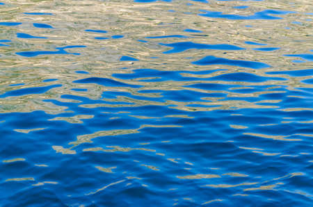 Sea surface with sun reflections suitable as a background
