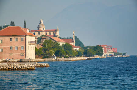 Old coastal houses and a church on a sea shoreの写真素材