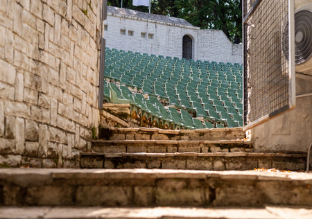 Stone steps and gate leading to an open-air amphitheater.