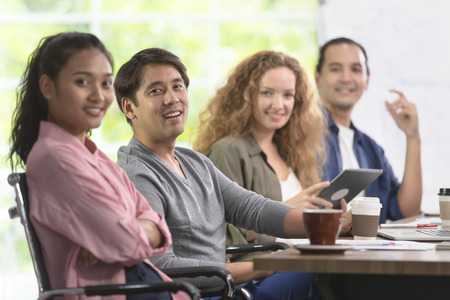 Group of Asian and caucasian businessmen is meeting his work. And happily smile at their job. In the...