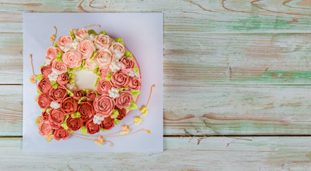 Fresh fascinating cake decorated topping as exquisite flower bouquets of pink roses served with creative heart for romantic present of wedding anniversary event and valentine to celebrate sweet love.の写真素材