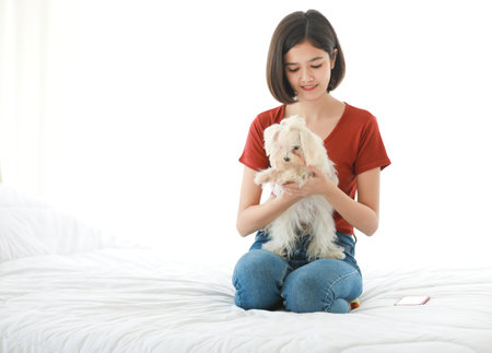 Studio shot of Asian young happy teenager short hair female girl model in casual outfit sitting...
