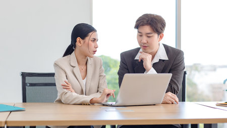 Asian professional successful male businessman and female businesswoman in formal business wear...