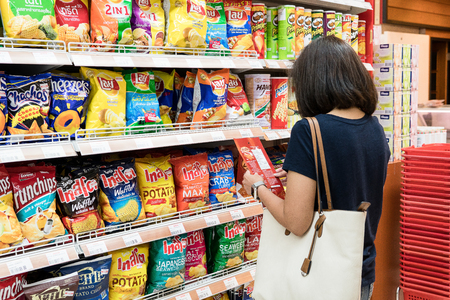 Foodland Superstore, Bangkok, Thailand - May 20, 2017: Middle aged women is buying snacks. By choosing from the nutrition and calories.のeditorial素材