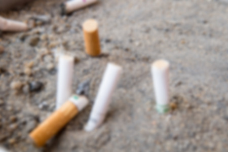 Blurry Background of Cigarette butts dumped onto the cigarette trash can. Closed-up.の写真素材