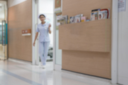Blurry Background of Nurse walked out of the examination room. Call patient into examination.の写真素材