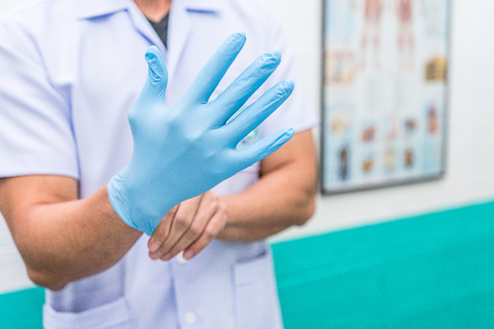 Male Nurse are wearing sterile gloves to preparation for wound treatment.の写真素材