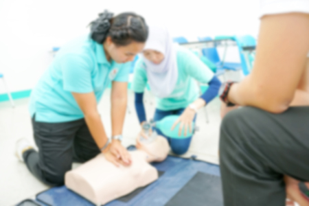 Blurry Background of Nursing students are learning how to rescue the patient in emergency. CPR training with CPR doll.の写真素材