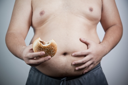 Fat man with hamburger isolatedの写真素材