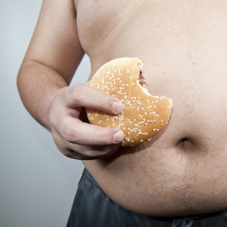 Fat man with hamburger isolatedの写真素材
