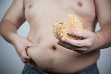 Fat man with hamburger isolatedの写真素材