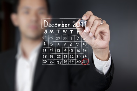 Male hand drawing a calendarの写真素材
