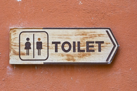 Ancient toilet sign on cement wallの写真素材