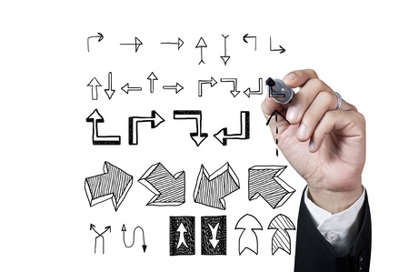 Hand with pen drawing arrow symbol on whiteboardの写真素材