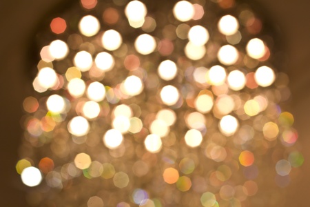 Defocused gold bokeh background with yellow, orange, green and white lightsの写真素材
