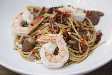 Asian spicy spaghetti with shrimp and herbの写真素材