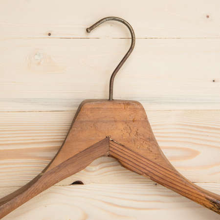 Old wooden hanger on wooden backgroundの写真素材