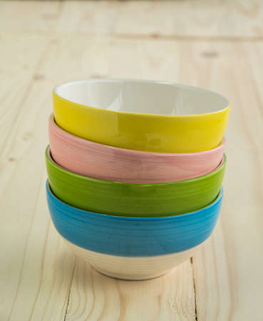 Stack of Colorful Bowls on Wooden Backgroundの写真素材