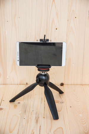 Mini tripod on wooden backgroundの写真素材