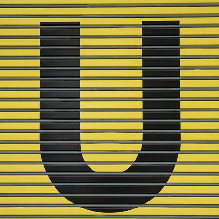 Type Alphabet On Yellow Wallの写真素材