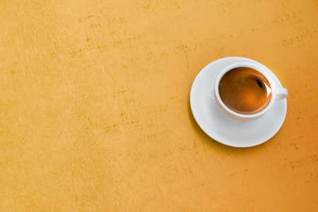 Coffee on yellow wood background