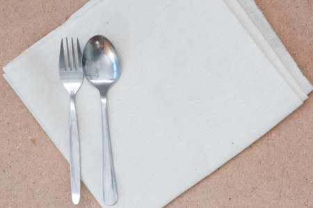 Spoon and Fork on Calico and Wooden Boardの写真素材