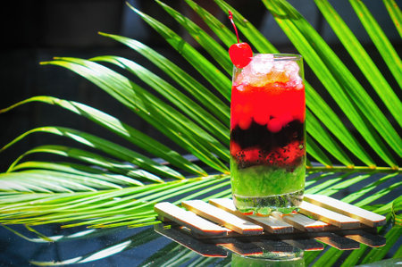 ice mixed with fruit filled with sticky rice tapai with a coconut leaf backgroundの写真素材