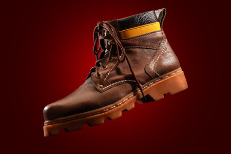 Protective semi-boots designed for safety and durability in red backgroundの写真素材