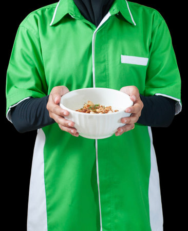 close up detail of a female chef carrying a bowl of porridge ready to be served. isolated on black...