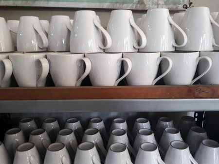 glasses mug for coffee on glass shelvesの写真素材