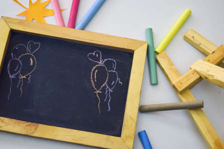 Vintage rectangular chalkboard with colorful chalk isolated on white backgroundの写真素材