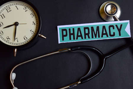 Pharmacy on the paper with Healthcare Concept Inspiration. alarm clock, Black stethoscope.の写真素材