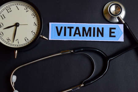Vitamin E on the paper with Healthcare Concept Inspiration. alarm clock, Black stethoscope.の写真素材