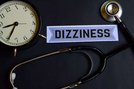 Dizziness on the paper with Healthcare Concept Inspiration. alarm clock, Black stethoscope.の写真素材