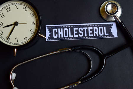Cholesterol on the paper with Healthcare Concept Inspiration. alarm clock, Black stethoscope.の写真素材