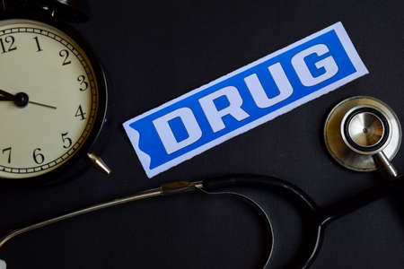 Drug on the print paper with Healthcare Concept Inspiration. alarm clock, Black stethoscope.の写真素材