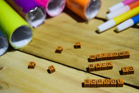 Welcome Back to School on wooden cubes with colorful paper and pen, Concept Inspiration on Wooden backgroundの写真素材