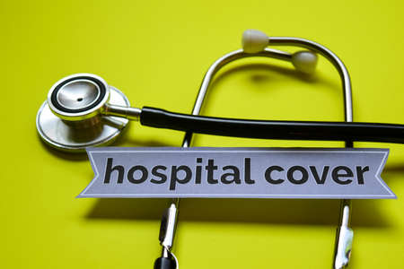 Closeup Hospital Cover with stethoscope concept inspiration on yellow background