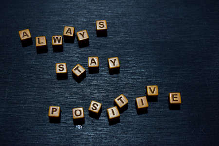 Always stay positive message written on wooden blocks. Motivation concepts. Cross processed imageの写真素材