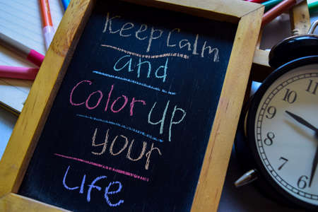 Keep calm and color up your life on phrase colorful handwritten on chalkboard, alarm clock with motivation and education conceptsの写真素材