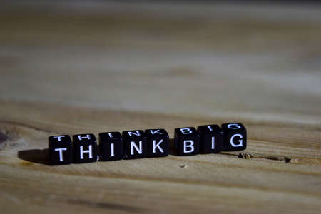 Think big on wooden blocks. Motivation and inspiration concept. Cross processed imageの写真素材