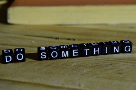 Do something on wooden blocks. Motivation and inspiration concept. Cross processed image