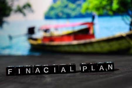 Financial plan on wooden blocks. Business and finance concept. Cross processed image with bokeh backgroundの写真素材