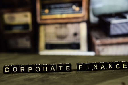Corporate finance on wooden blocks. Business and finance concept. Cross processed image with bokeh backgroundの写真素材